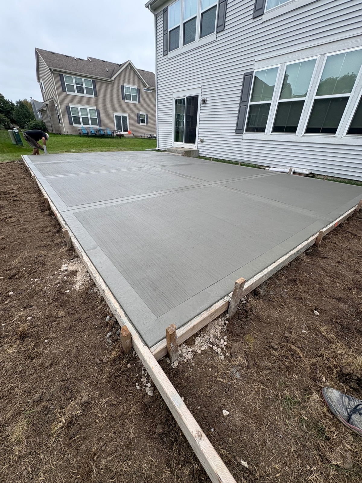 New concrete patio with control joints and wood framing