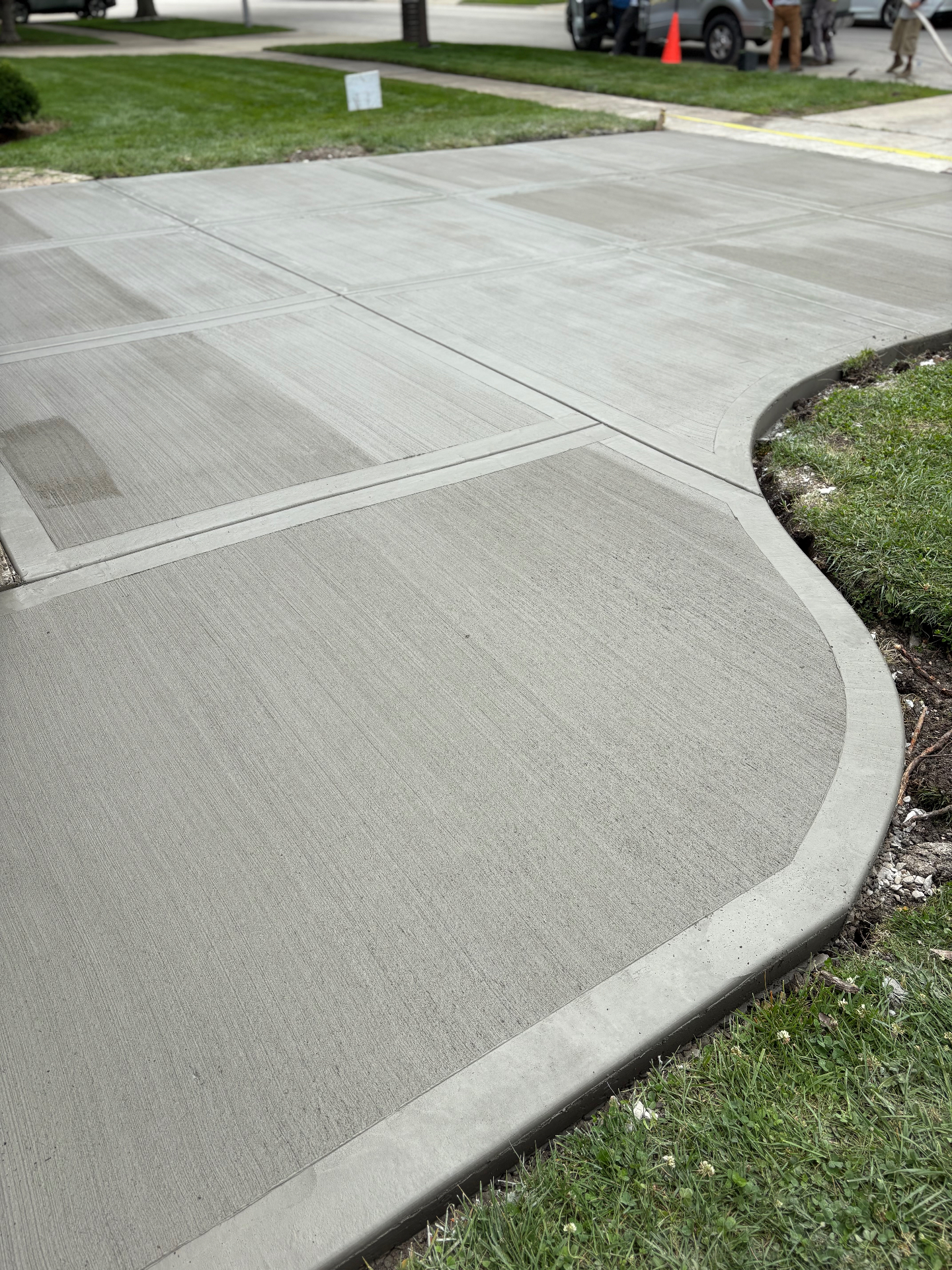 Curved concrete driveway with decorative edging