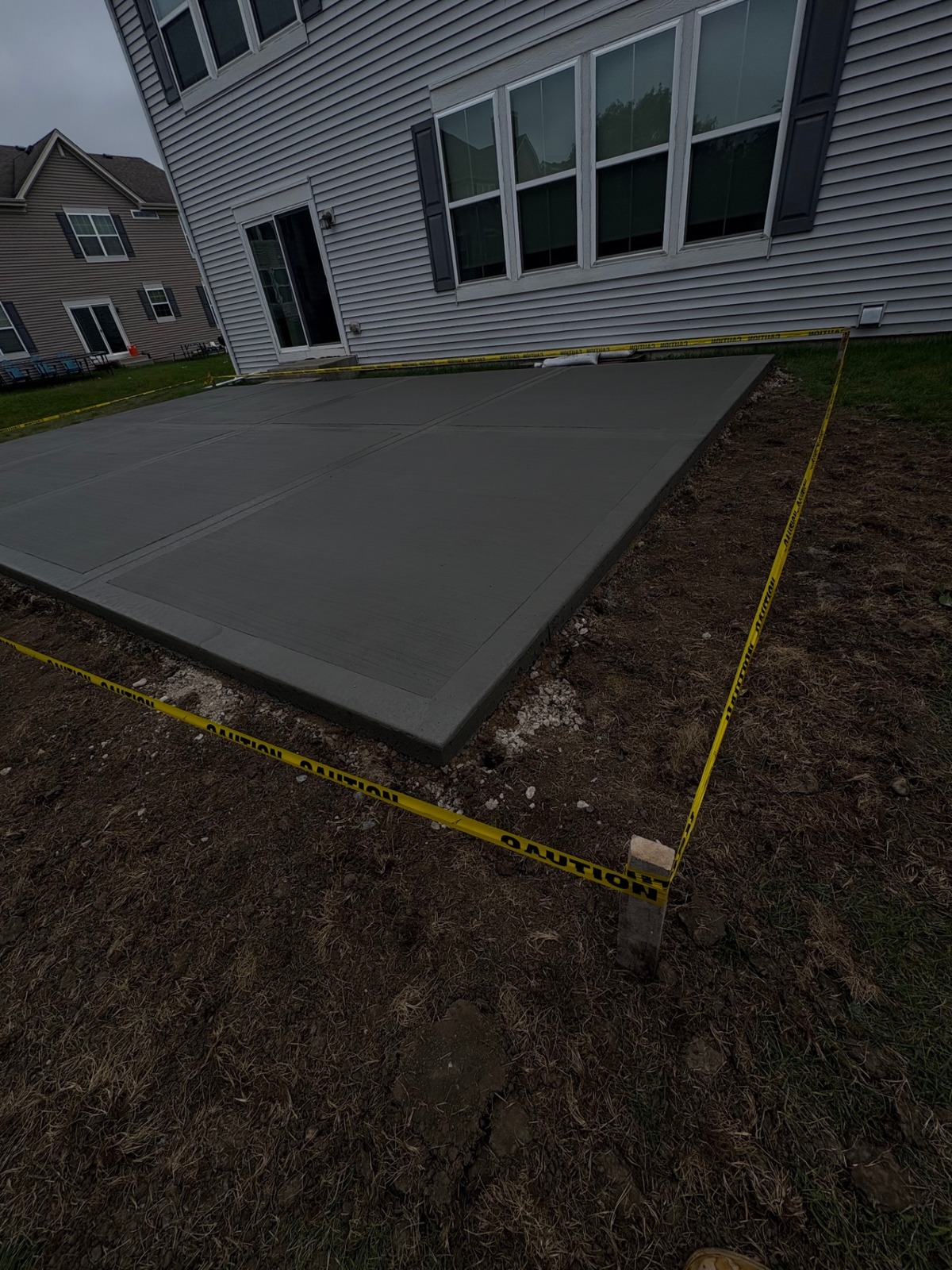 Angled view of freshly poured concrete patio
