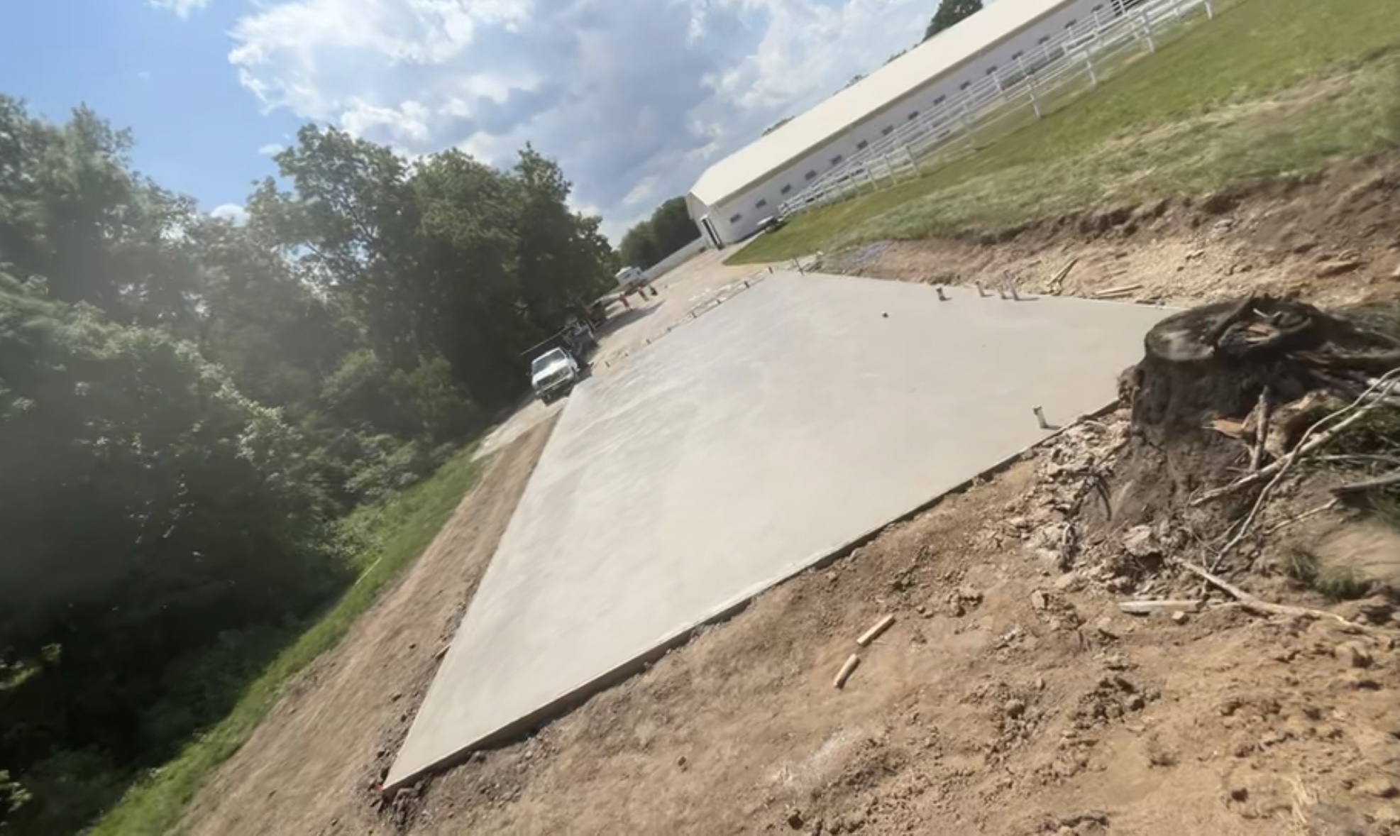 Freshly poured concrete pad on graded site